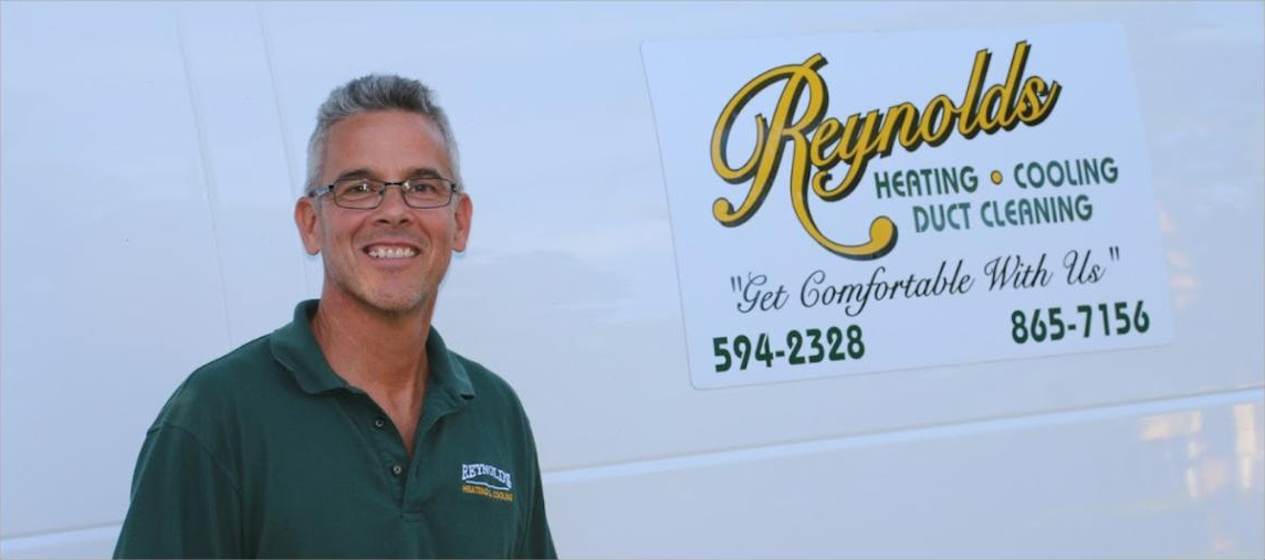 Brian Reynolds beside the Reynolds Heating, Cooling and Duct Cleaning van